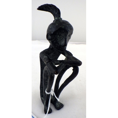 405 - An African stylized figurine, cast bronze. 15cm tall