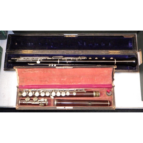 472 - A flute, cracks, and an oboe, both in wooden cases. The maker of the oboe identified as J. Sharpe of... 