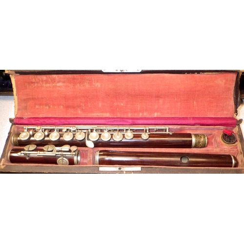 472 - A flute, cracks, and an oboe, both in wooden cases. The maker of the oboe identified as J. Sharpe of... 