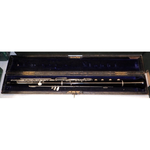 472 - A flute, cracks, and an oboe, both in wooden cases. The maker of the oboe identified as J. Sharpe of... 