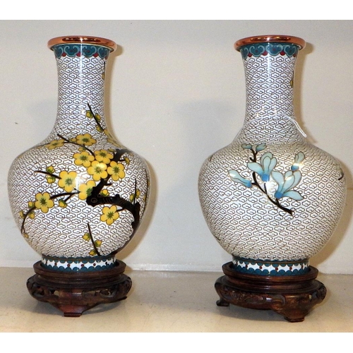 366 - A pair of cloisonne vases on wooden stands