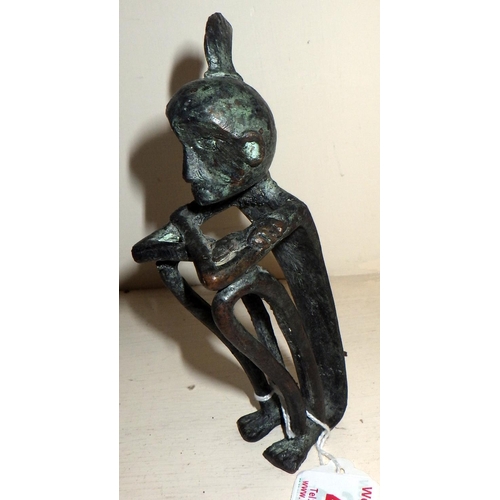 405 - An African stylized figurine, cast bronze. 15cm tall