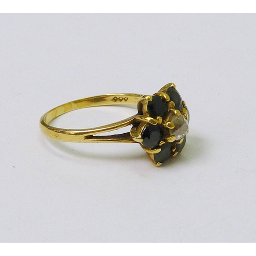 77 - A daisy cluster ring, 18ct gold set with sapphires around a central diamond.  Head 12mm across / cen... 