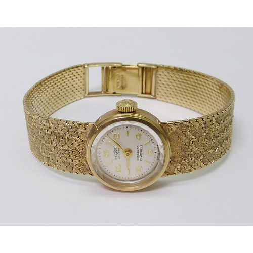 87 - A Record ladies bracelet wristwatch having a manual wind movement in a 9ct gold case on an integral ... 