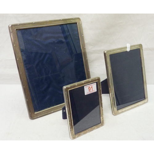 91 - Three graduated photograph frames, silver with blue velvet covered backs.  Modern.  Largest 200 x 25... 
