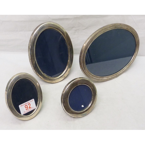 92 - Three oval photograph frames, oval with blue velvet covered backs; another circular example.  Modern... 