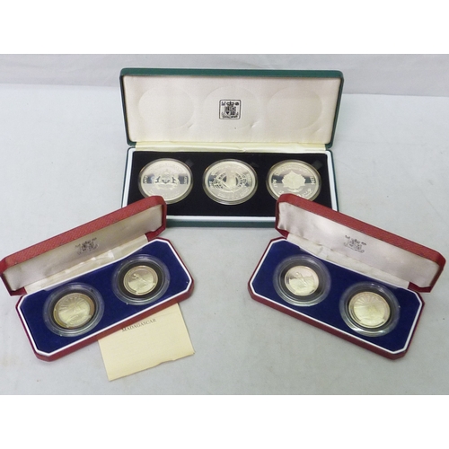 126 - A Royal Mint Morocco 50 Dirhams silver proof three coin set, 1975 / 1976, cased; two Royal Mint The ... 