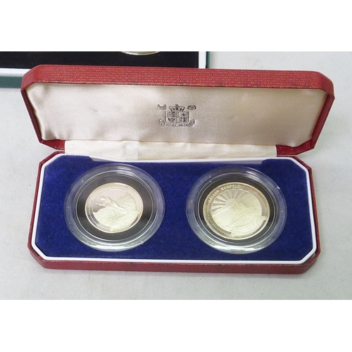 126 - A Royal Mint Morocco 50 Dirhams silver proof three coin set, 1975 / 1976, cased; two Royal Mint The ... 