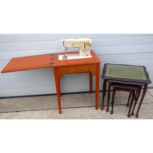 880 - A Singer sewing machine, missing leads, together with a nest of tables, leg loose (2)