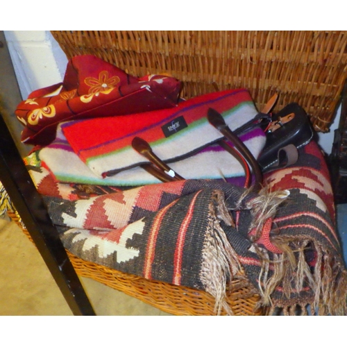 891 - A wicker hamper, kilim rug, textiles etc