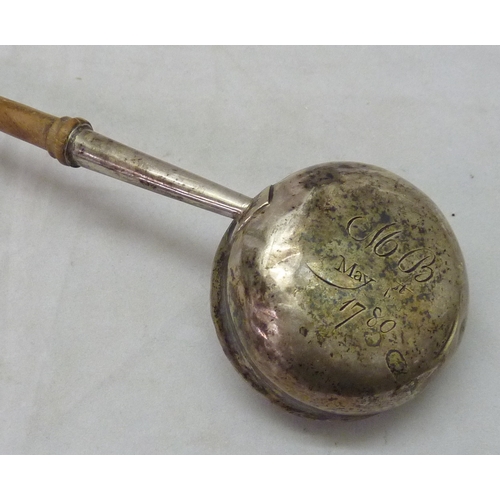 135 - A George III toddy ladle, unmarked white metal and turned wood, the bowl base engraved 