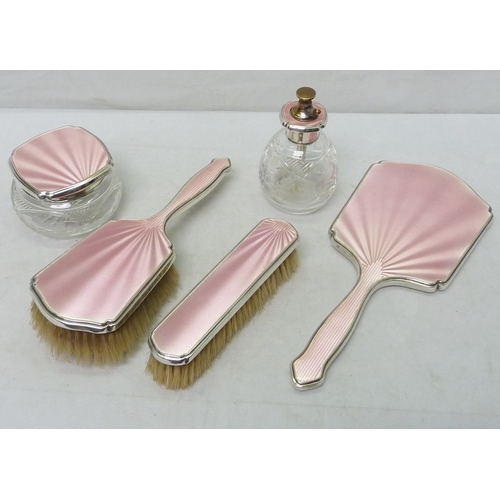 45 - A cased five part brush set, silver with pink enamel over engine turning. A/F - slight chips, brush ... 