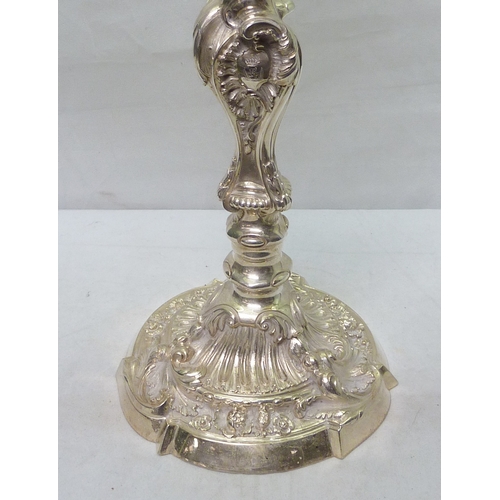 96 - A Victorian candelabra having cast and chased rococo decoration, the sconces and stem engraved with ... 