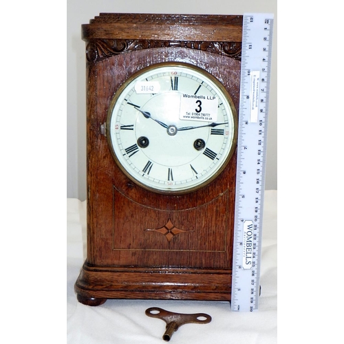 3 - An oak cased inlaid mantle clock 31cm tall