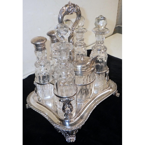 316 - A cruet set, comprising a silver plated stand holding seven cut glass bottles, three having silver l... 