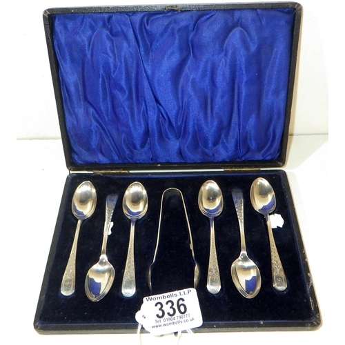 336 - A cased set of six silver coffee spoons with matching tongs. 65g