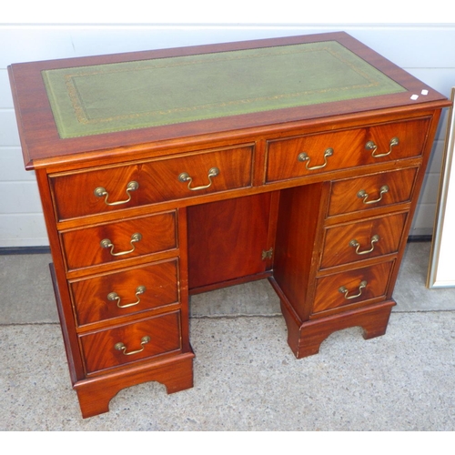 609 - A reproduction mahogany kneehole desk with green leather inset top, 91cm wide