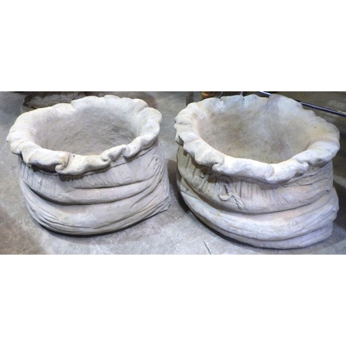 802 - A pair of concrete sack shaped garden planters 25cm tall