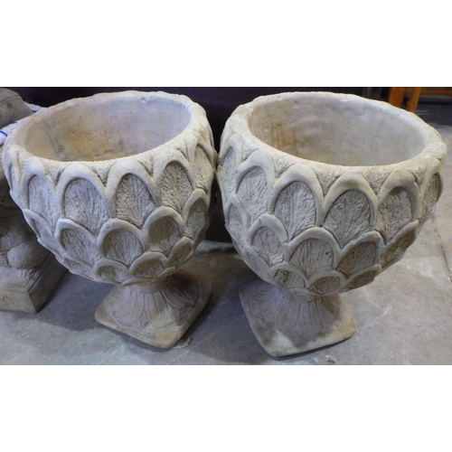 760 - A pair of pineapple shaped concrete planters 50cm tall