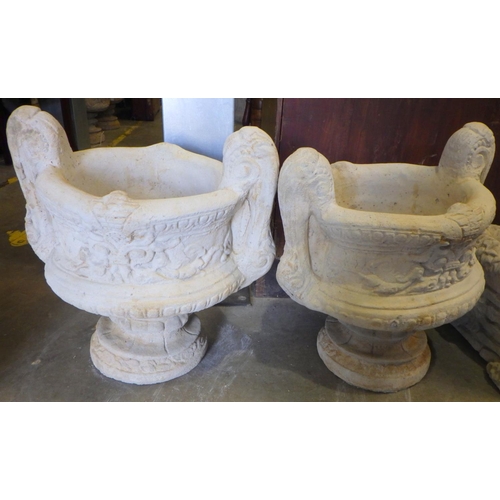 763 - A pair of concrete two handled garden urns