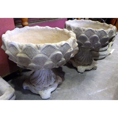 765 - A pair of concrete garden planters 50cm tall