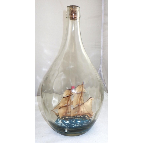 111 - A ship in a bottle with another in the neck on a wooden stand together with another ship in a bottle... 