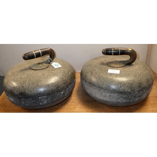 126 - A pair of curling stones of Ailsa Craig granite with ebonised handles each bearing a vacant escutche... 