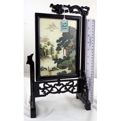 131 - A small wooden framed silk embroidered table screen depicting an oriental rural scene