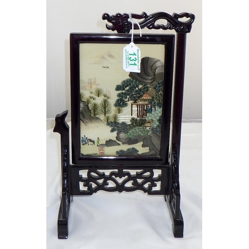 131 - A small wooden framed silk embroidered table screen depicting an oriental rural scene