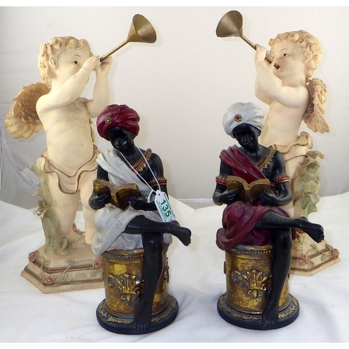 135 - A pair of cherub figures blowing horns together with a pair of 'Blackamore' figures reading