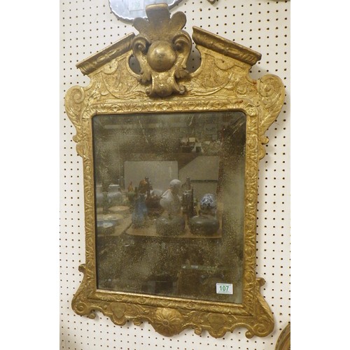 A rectangular wall mirror having, gesso and gilt frame having a broken pediment top, lightly bevelled plate foxed.  Whole 53 x 78cm