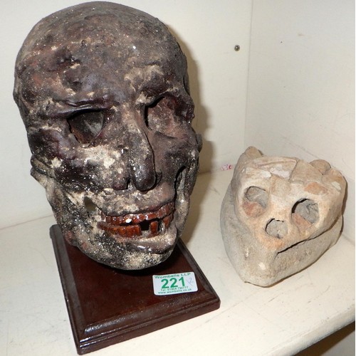 221 - A resin skull together wit a stone skull (2)