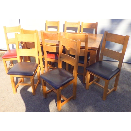 778 - A large modern oak extending dining table with 10 matched chairs