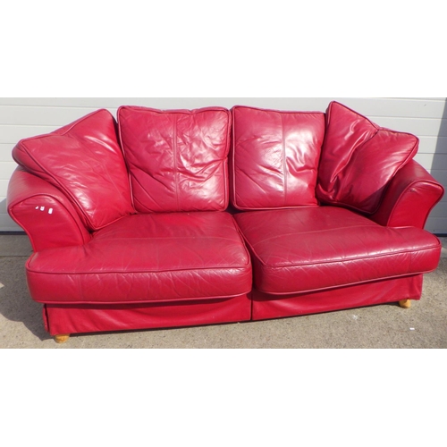 794 - A large red leather sofa, a/f split