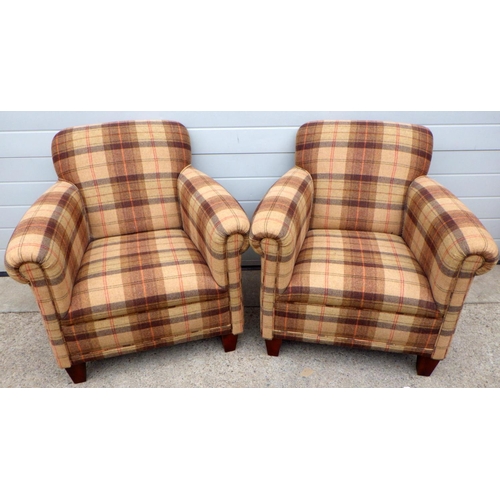 827 - A pair of check upholstered easy chairs, small hole in one seat