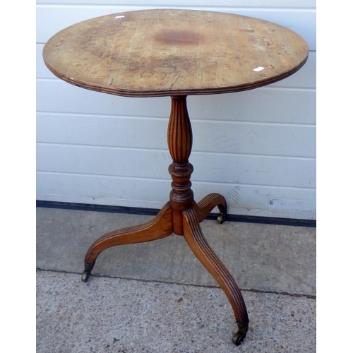 835 - A tripod table on reeded downswept legs, top repaired & warped
Sold on behalf of the Terry family Yo... 