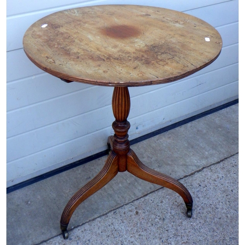 835 - A tripod table on reeded downswept legs, top repaired & warped
Sold on behalf of the Terry family Yo... 