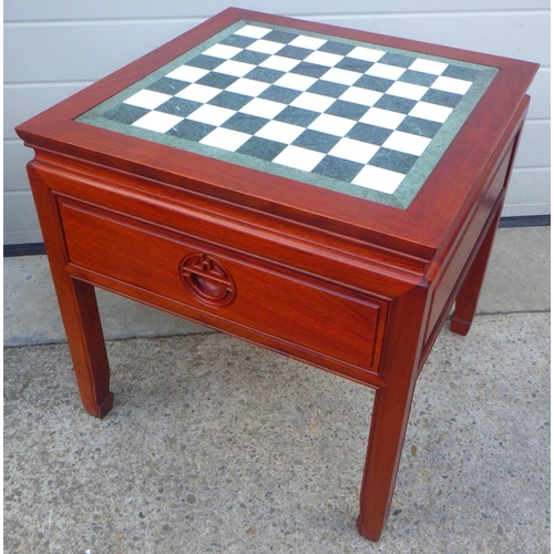 847 - A Chinese hardwood occasional table with marble chessboard top and two drawers, 56cm wide