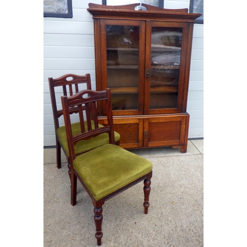 850 - A 1930's oak cabinet, 105cm wide, together with a pair of late Victorian dining chairs (3)