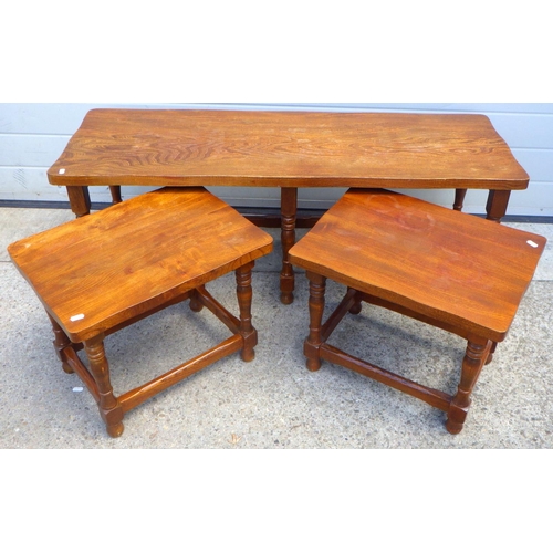 863 - An elm coffee table, 122cm long with two under tables