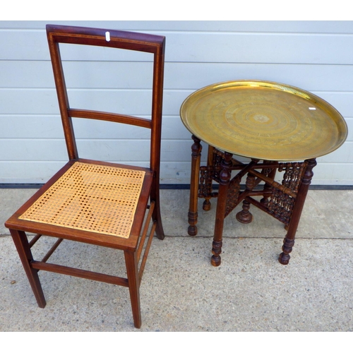 865 - A brass topped Benares folding table, 58cm across, together with a bedroom chair (2)