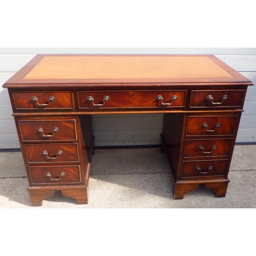 869 - A reproduction mahogany pedestal desk with brown leather inset top, 122cm wide