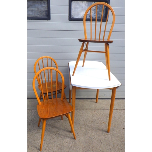 871 - A white drop leaf kitchen table and three Ercol chairs (4)