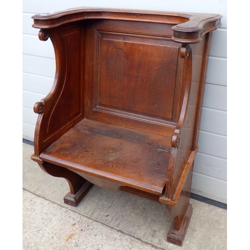 892 - A panelled oak church chair with hinged seat