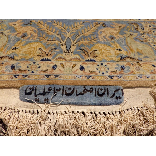 898 - A blue/beige ground rug with birds & animals 183cm x 105cm (a/f)
Sold on behalf of the Terry family ... 