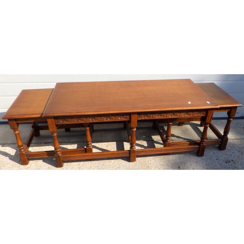 903 - An oak coffee table with two under tables, 115cm long