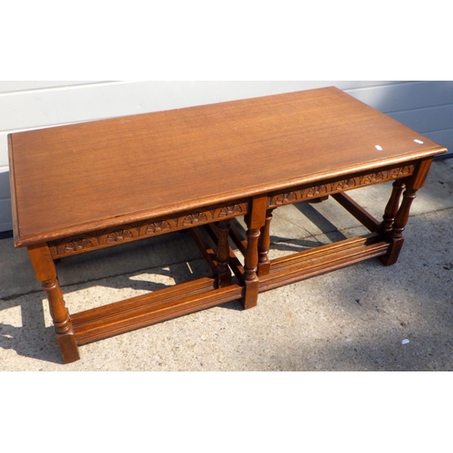 903 - An oak coffee table with two under tables, 115cm long