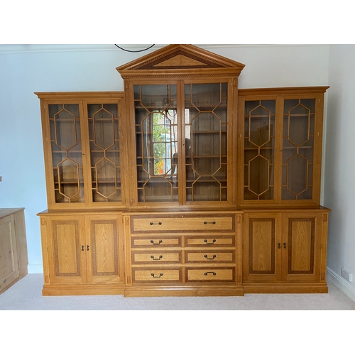 A Shaw & Riley oak breakfront bookcase with secretaire drawer, with Sea Horse motif