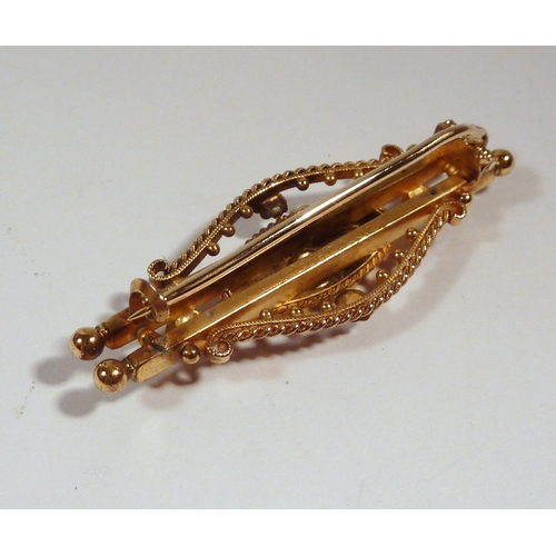 60 - An Edwardian bar brooch, 15ct gold set with a central diamond, 4g gross / 43mm long  / presented in ... 