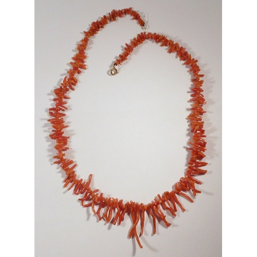 63 - A red coral necklace, 520mm long.